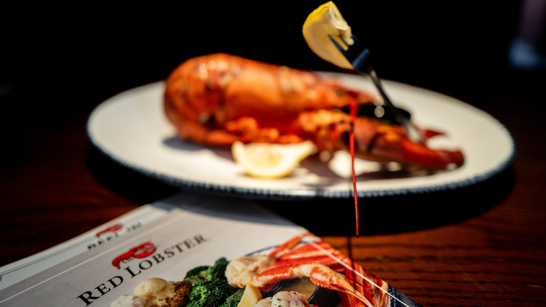 Red lobster menu and serving of lobster on plate