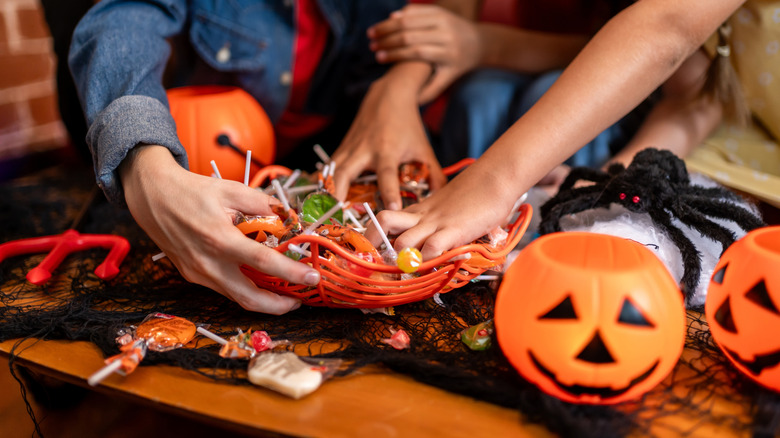 Kids reaching for Halloween candy