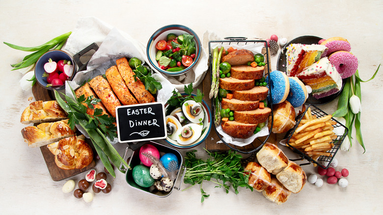Easter foods with fresh herbs around them