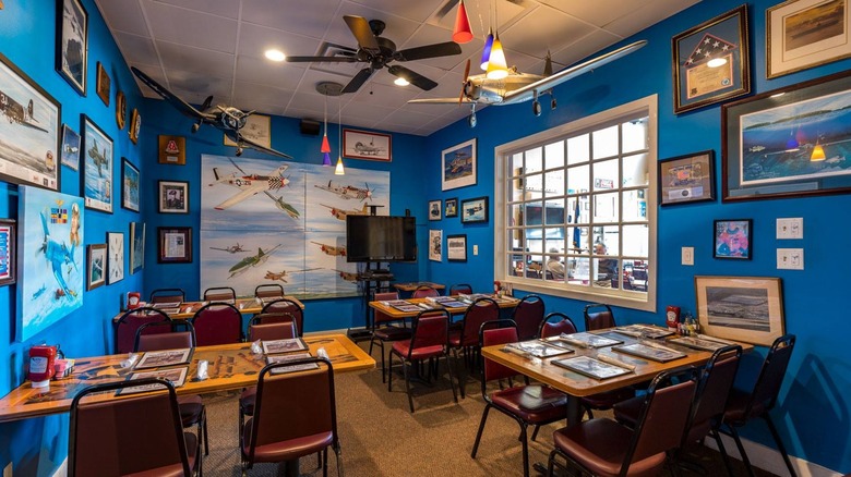 The Blue Room at Flight Deck Restaurant with tons of aviation photos and plane models hanging from the ceiling