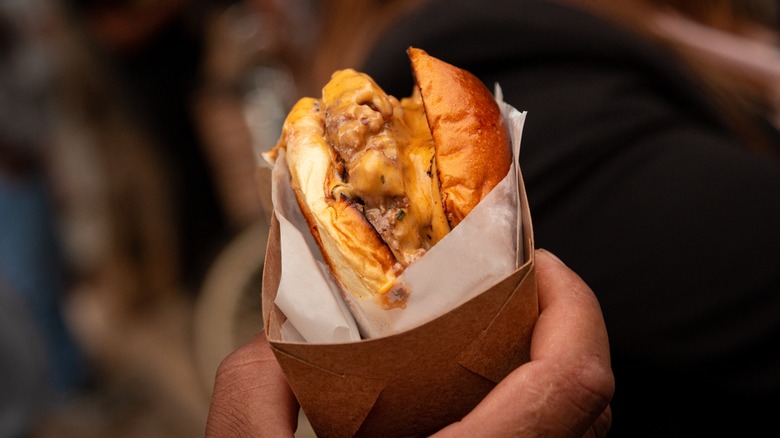 hand holding a smash burger