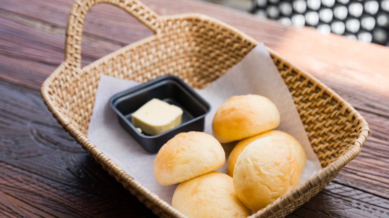 Bread rolls and butter in basket