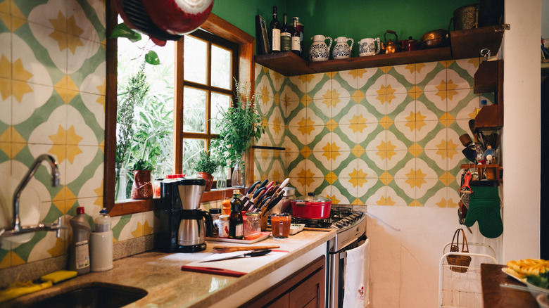 A vintage kitchen with patterned wallpaper