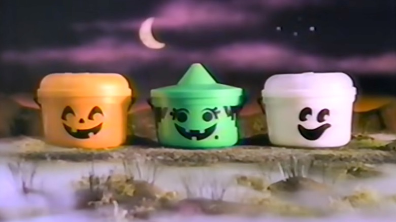 Three Boo Buckets from McDonald's on a dark, spooky background