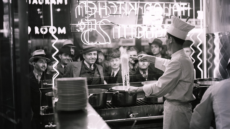 Spaghetti amatriciana, famous Italian recipe from Amatrice, with peeled tomatoes, pecorino cheese, bacon, extra virgin olive oil, white wine, pepper and chilli.