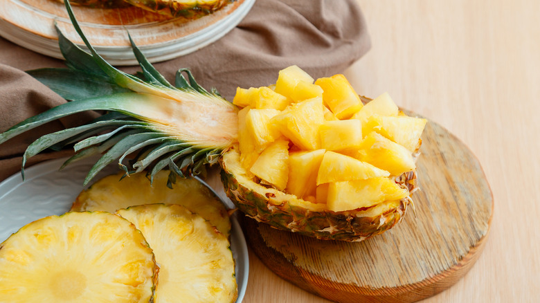 Fresh pineapple cubes in carved pineapple