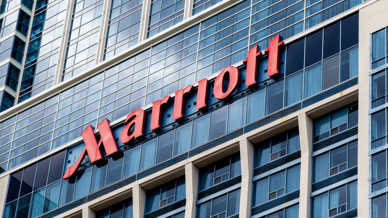 The exterior of a Marriott hotel, showing its large signage on the outside of the building