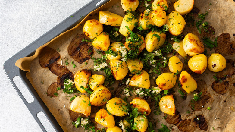 Roasted potatoes with herbs on a baking sheet