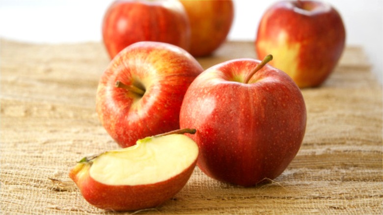 Apples and apple slice on mat  