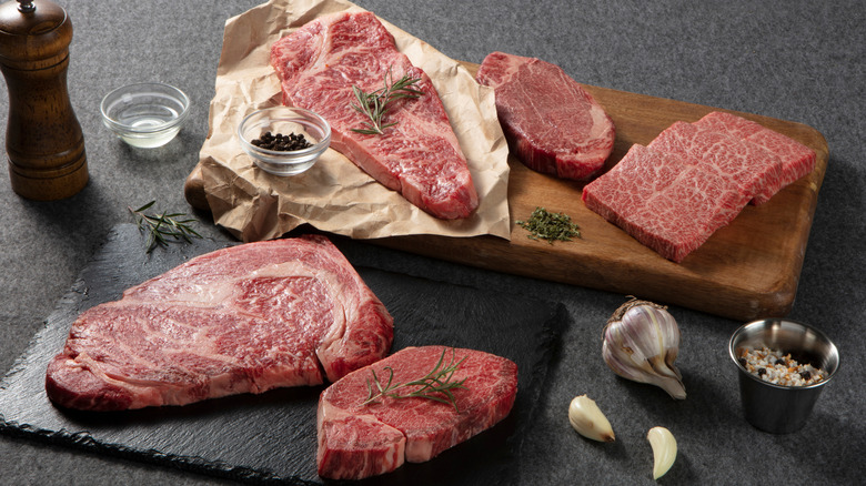 Cutting boards with different cuts of meat