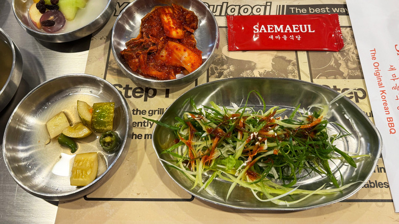 Banchan dishes of scallions and kimchi
