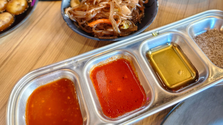 A tray of four Korean dipping sauces