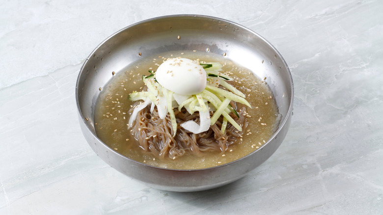A metal bowl of naeng-myeon