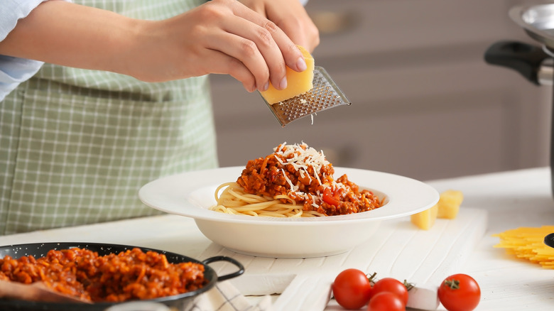 Woman cooking pasta bolognese