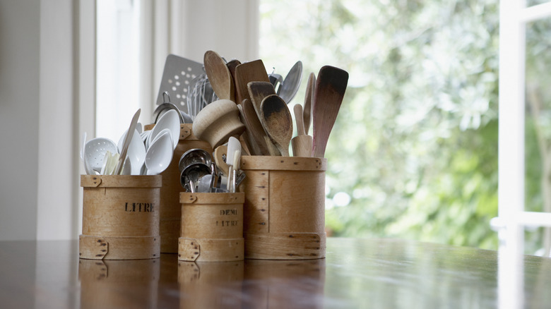 kitchen utensils in buckets on counter