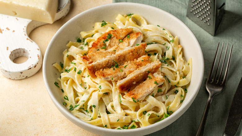 Fettuccini Alfredo with chicken in a bowl on a table