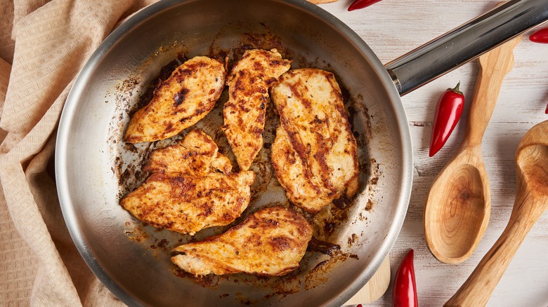 Chicken frying in pan