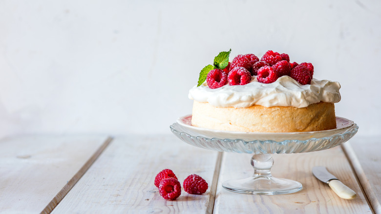 Angel cake topped with raspberries and cream