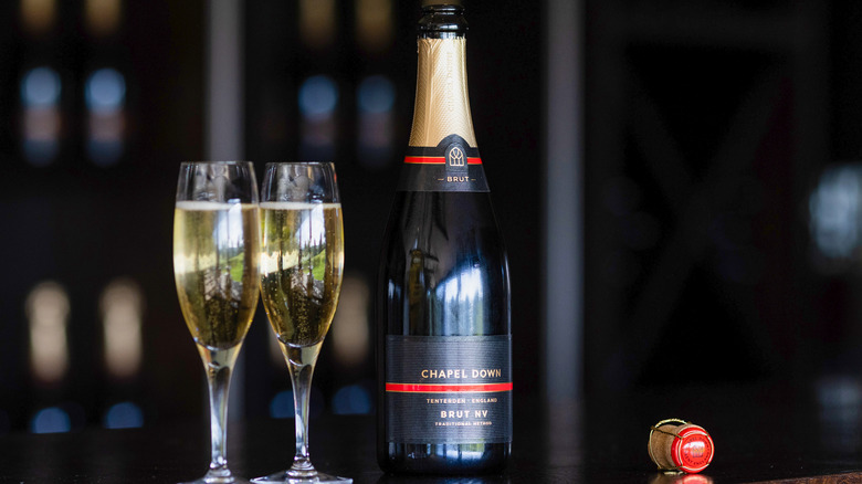 Two glasses of Brut with uncorked bottle
