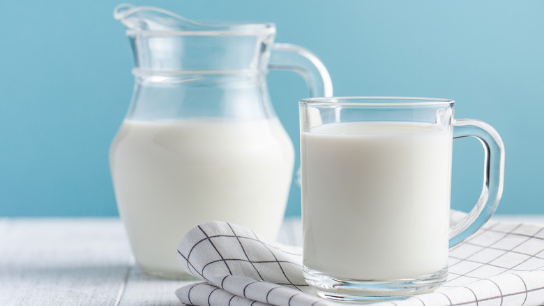 pitcher and cup holding milk