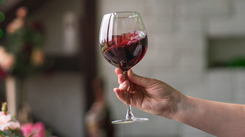 A person swirls a glass of wine