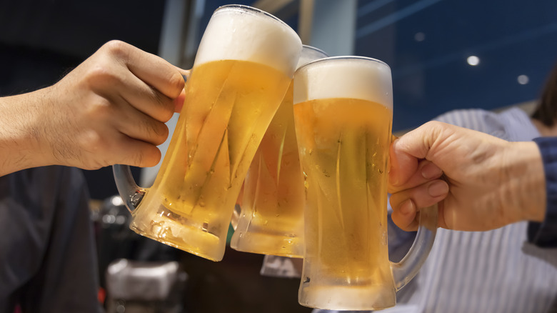 People cheersing foamy beer
