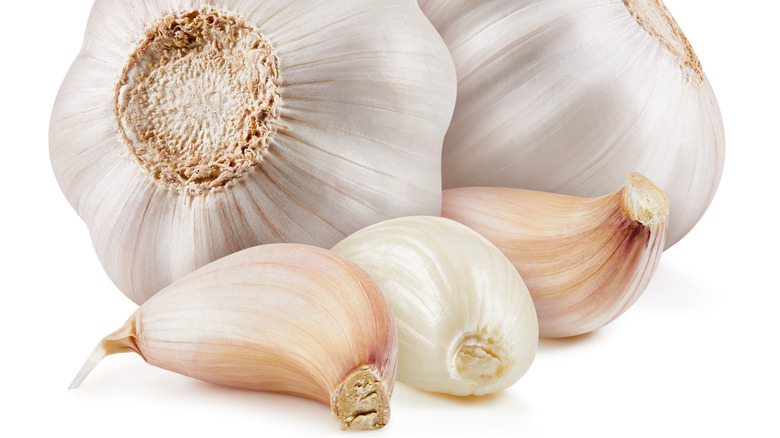 Garlic bulbs and cloves on white background