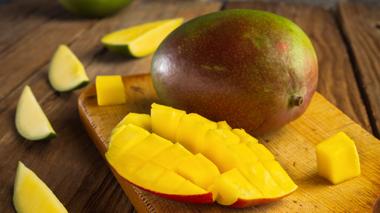 Sliced mangoes on cutting board