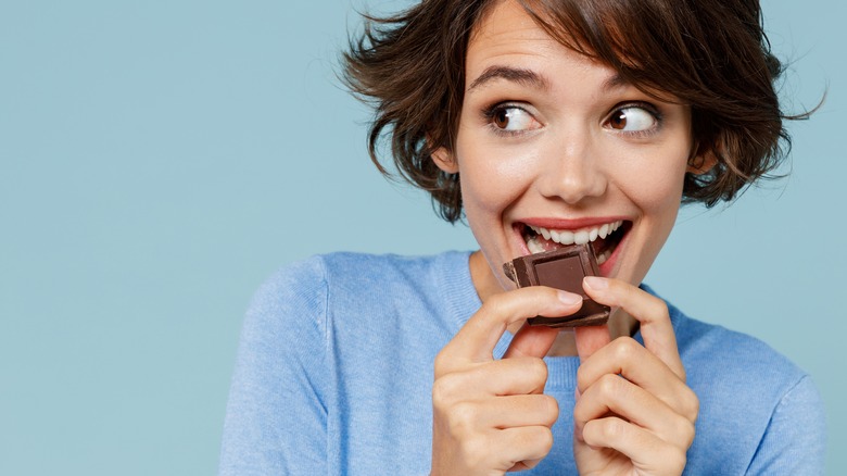 smiling woman eating chocolate