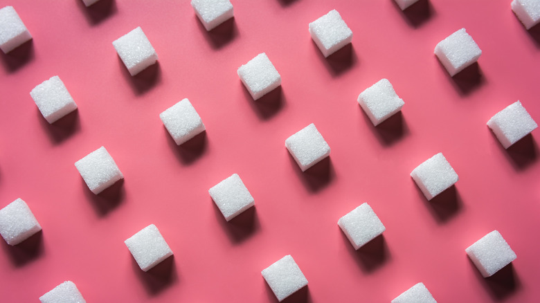 sugar cubes in rows pink background