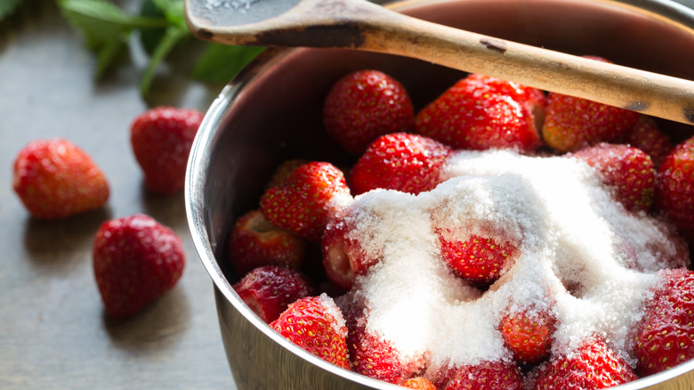 bowl of strawberries added sugar on top
