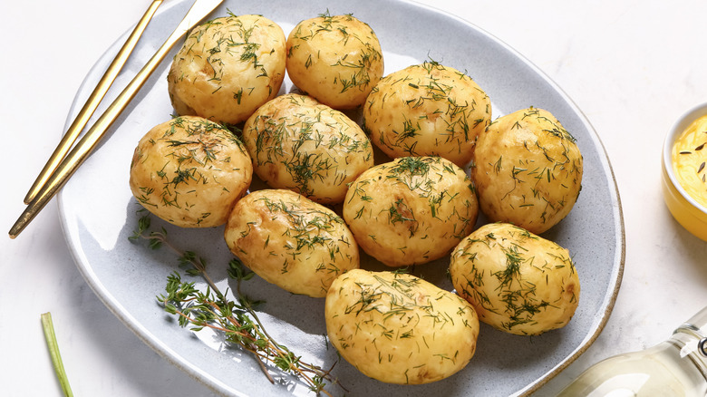 Plate of boiled baby potatoes with dill