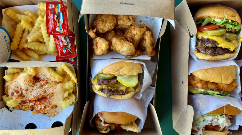 An assortment of different burgers, fries, and chicken items from Shake Shack