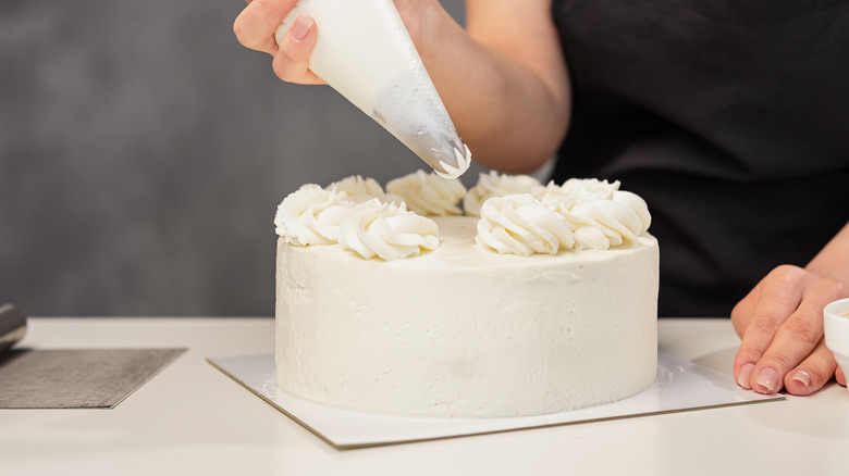 person frosting cake
