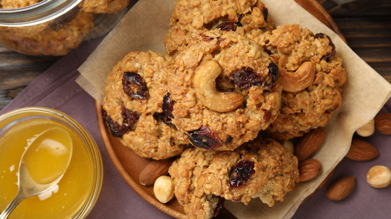 oatmeal cookies with cashews and dried cranberries made with melted butter, shown in a bowl