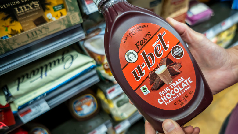 Person holding bottle of Fox's u-bet