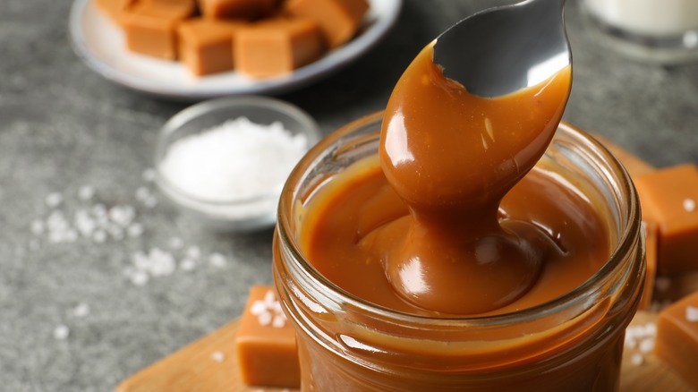 jar of butterscotch sauce with spoon