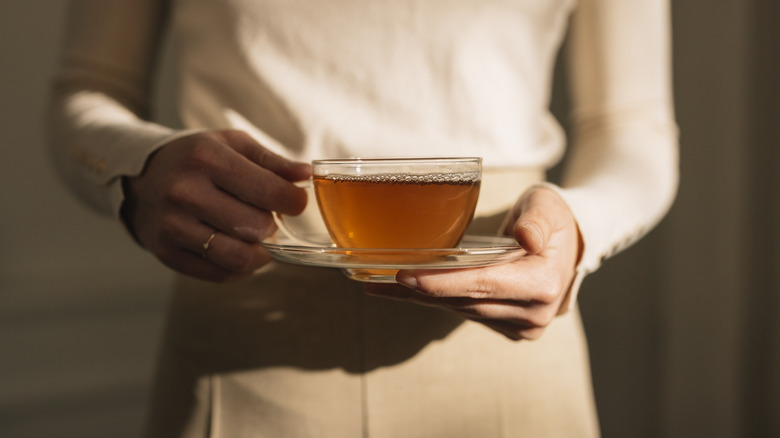 woman holding cup of tea