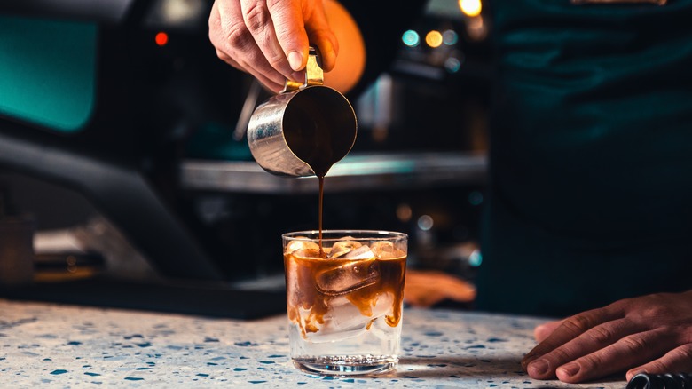 shot of espresso being poured into an espresso tonic