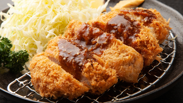 sliced katsu with sauce and cabbage