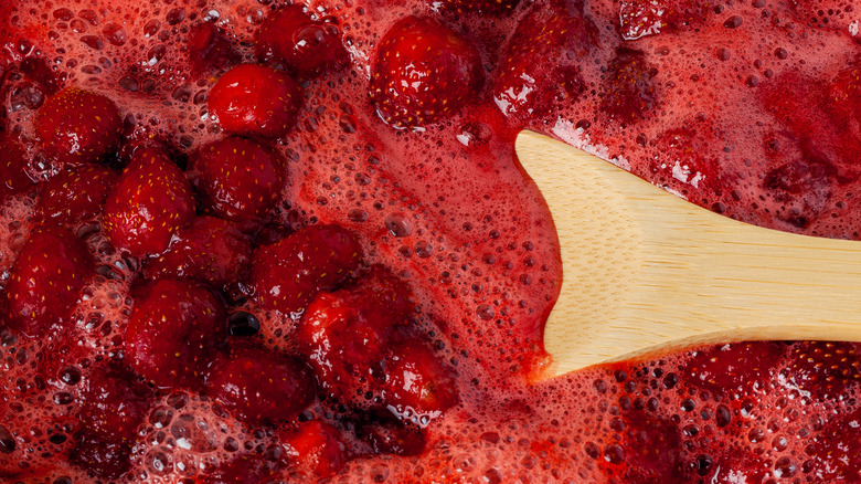 Frothy strawberry jam on spoon