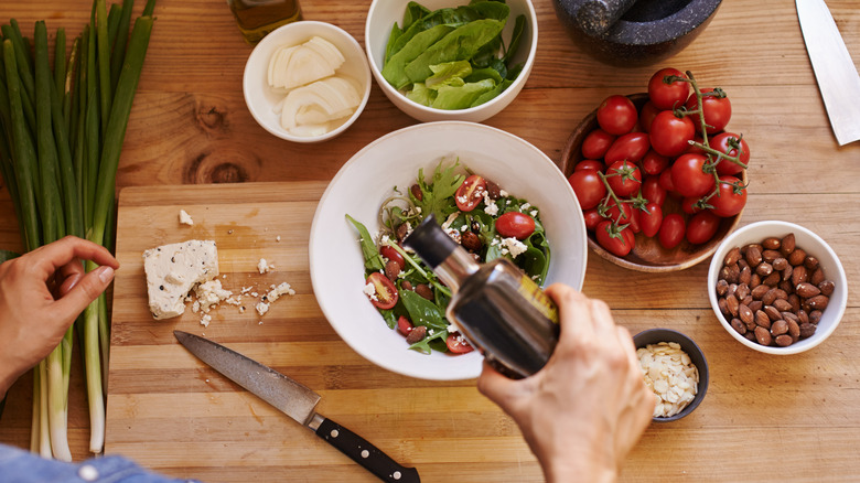 Pouring dressing over salad