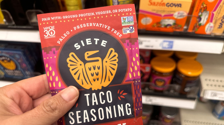 a red and pink packet of spicy taco seasoning