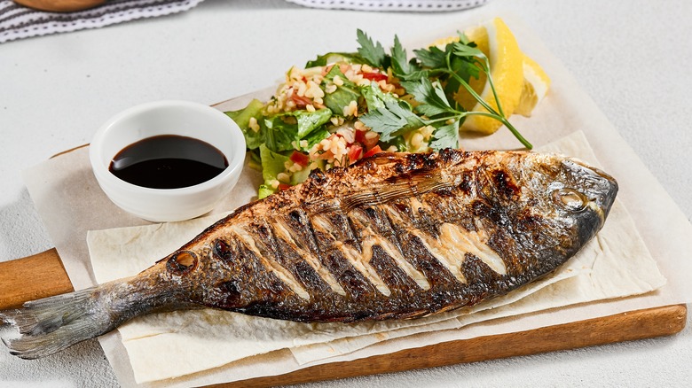 Grilled whole fish on board