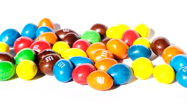 Colorful blend of M&M's pieces on white background