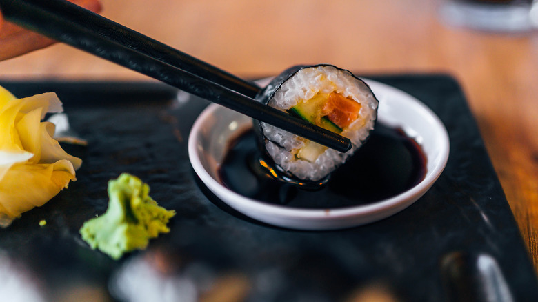 Dipping sushi in soy sauce