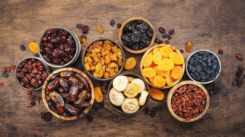 Different types of dried fruits in wooden bowls
