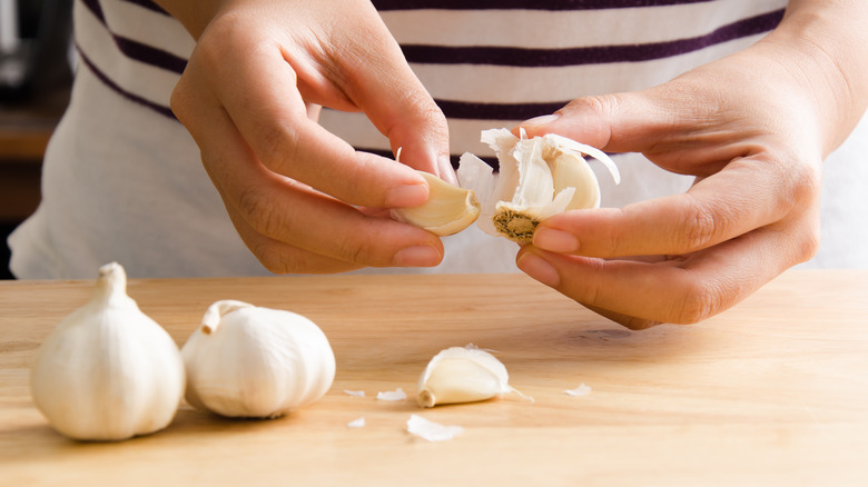 Person peeling garlic