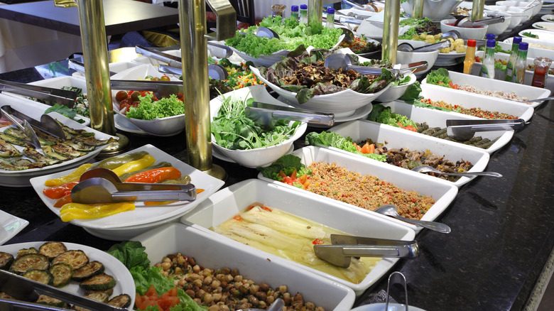 a variety of dishes on display at a salad bar