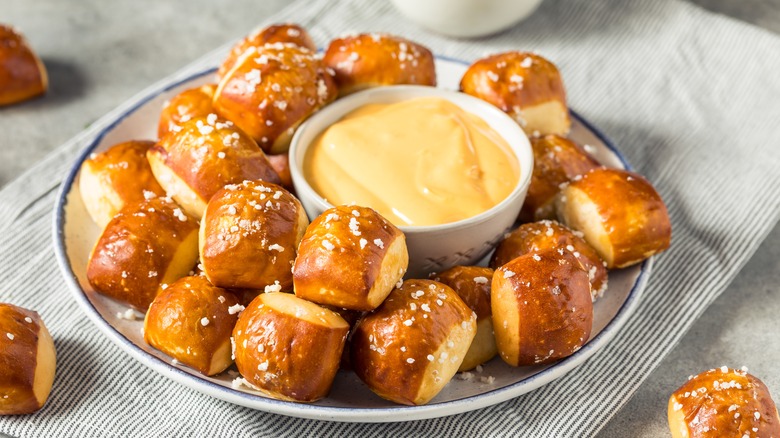 cup of beer cheese and pretzel bites on plate